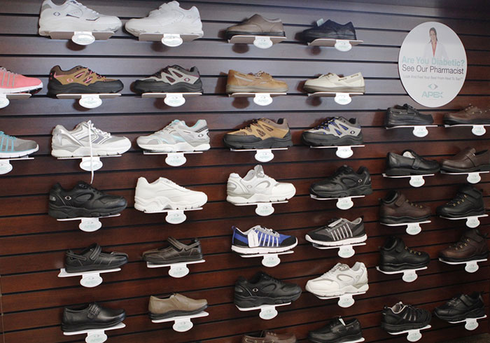 A wall displaying various styles of diabetic shoes