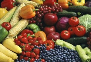 bunch of bananas, berries, tomatoes, corn showing good sources of fiber