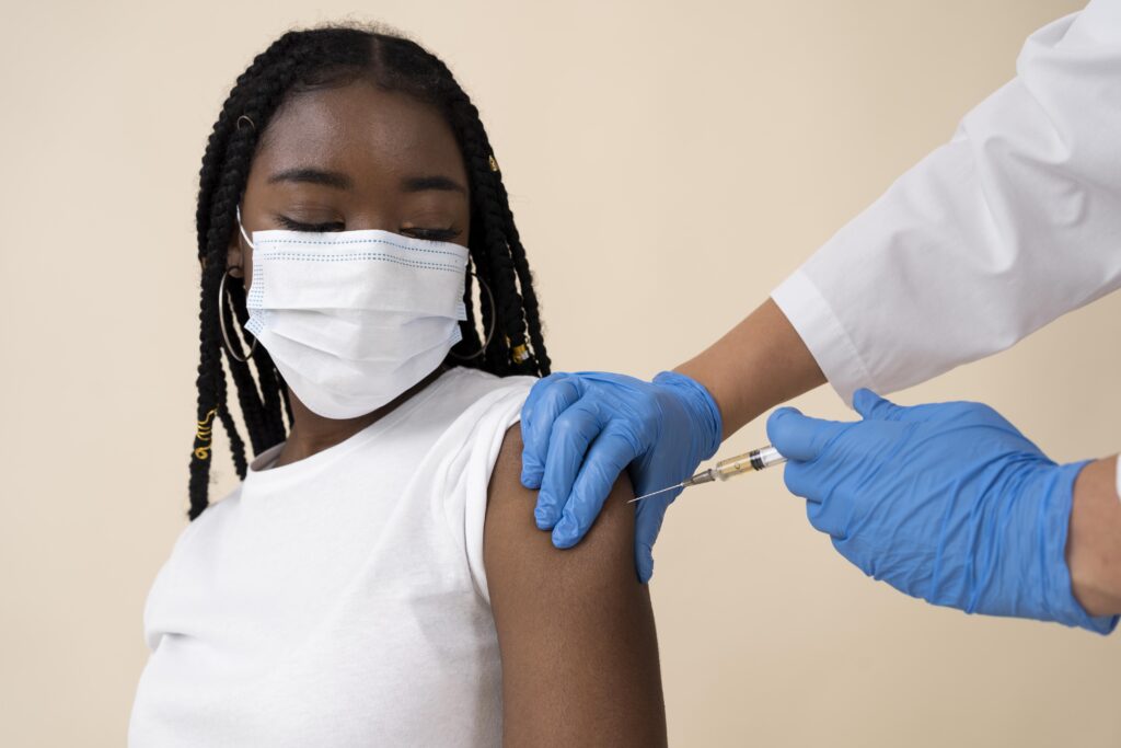 woman getting vaccine in arm