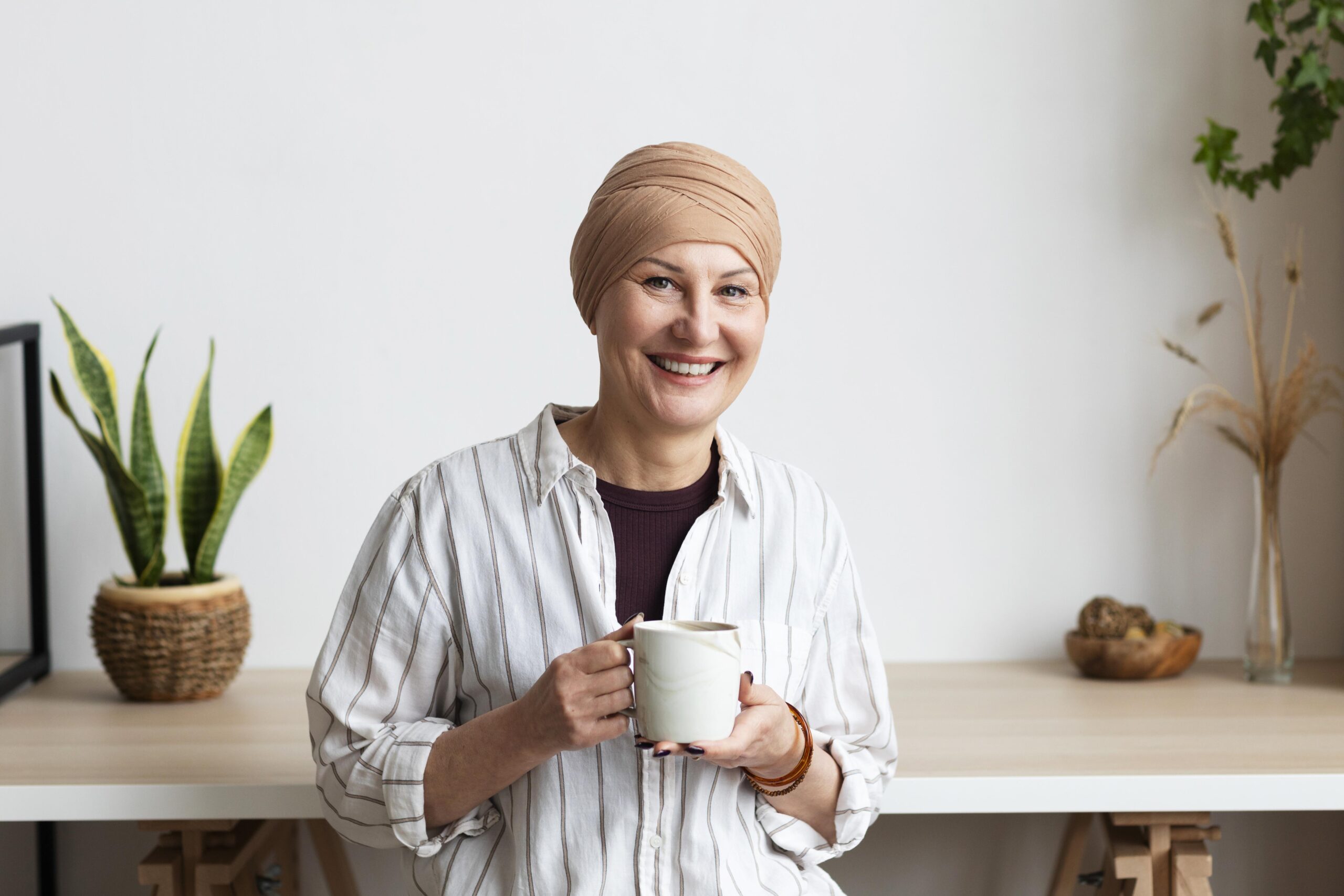 smiling woman with cap holding cup